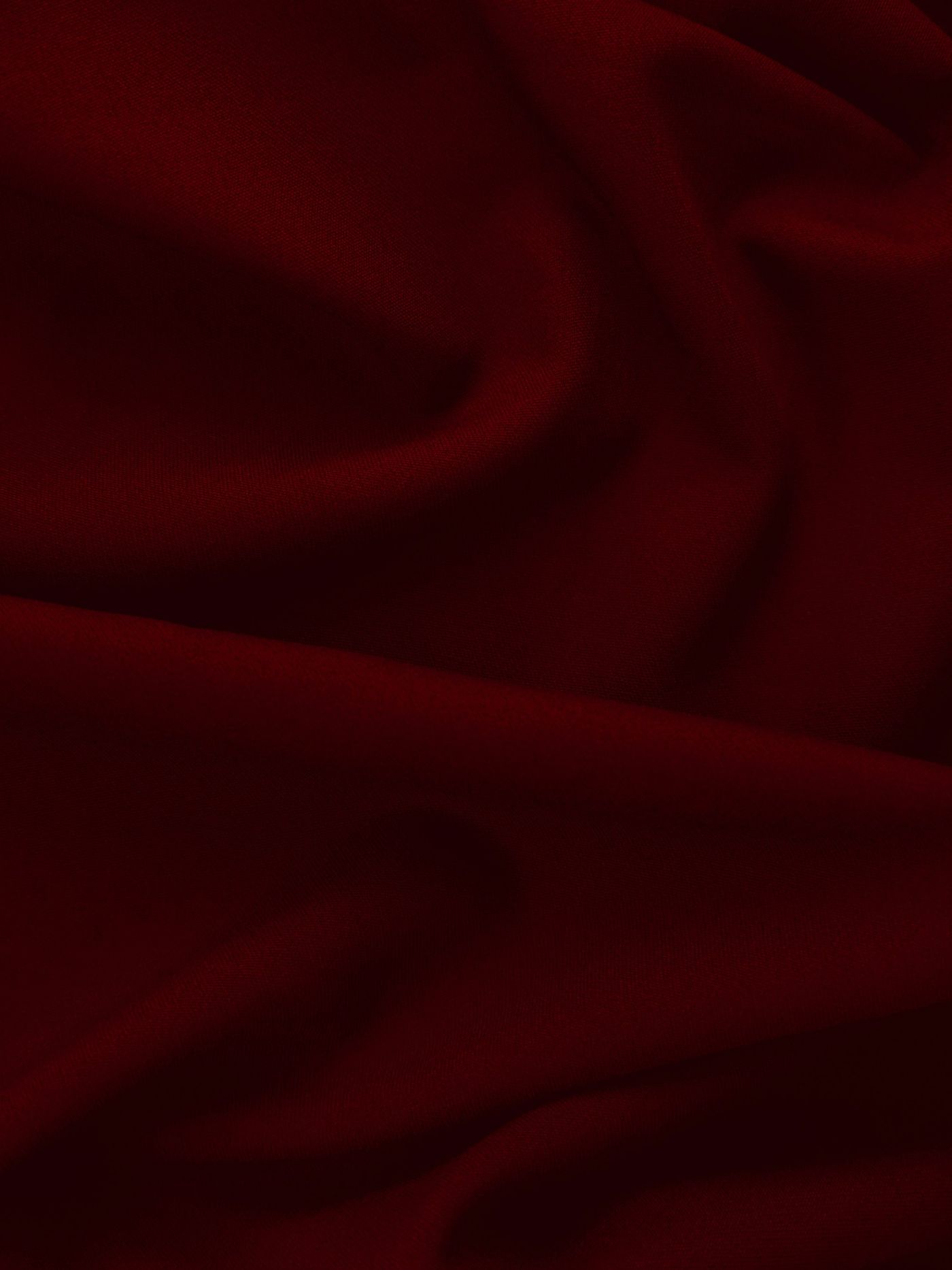 Deep burgundy red fabric draped in soft folds