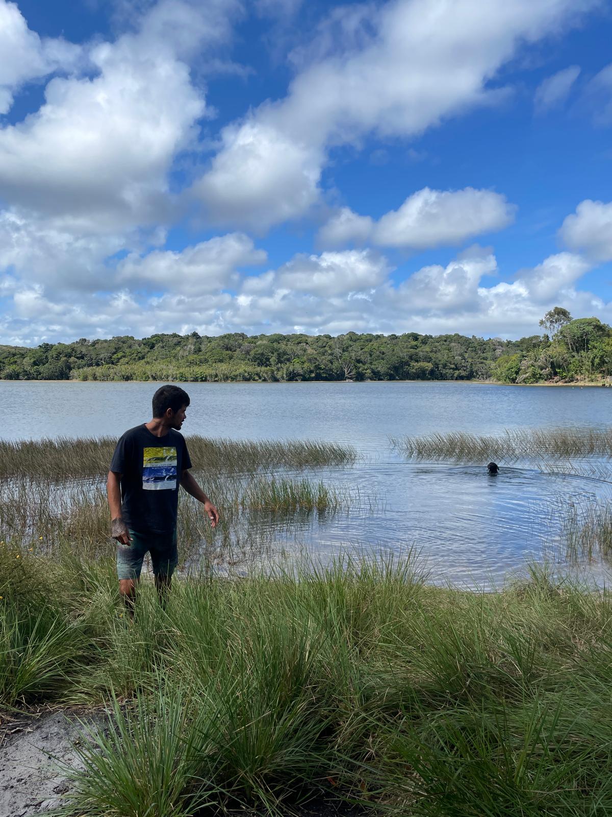 Ronald playing with Bagheera, his dog, in a lake in Brazil
