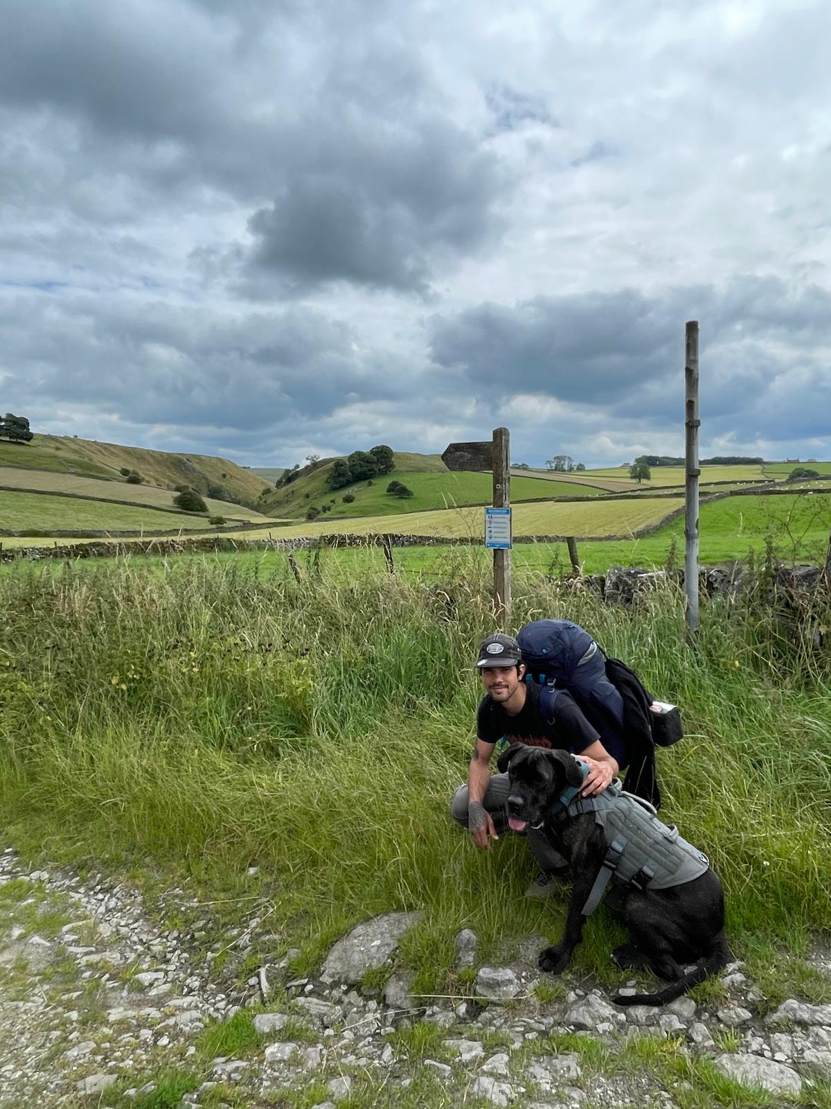 Ronald and Bagheera, his dog in a green field in the peak district