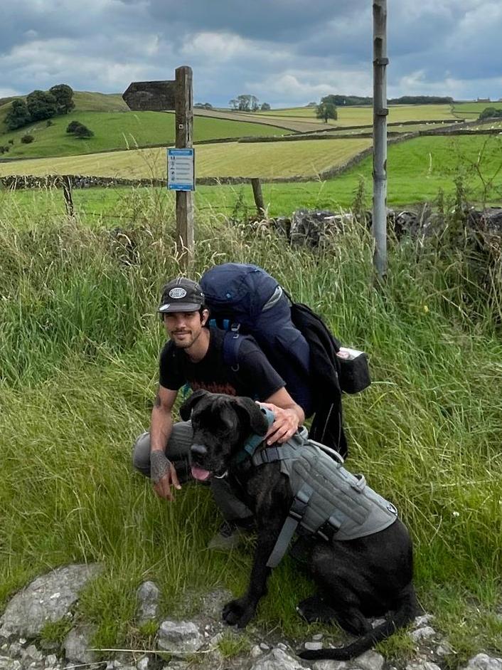 Ronald and Bagheera, his dog in a green field in the peak district