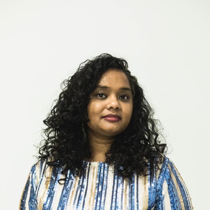 Headshot of Thenmozhi Soundararajan in front of a white background.