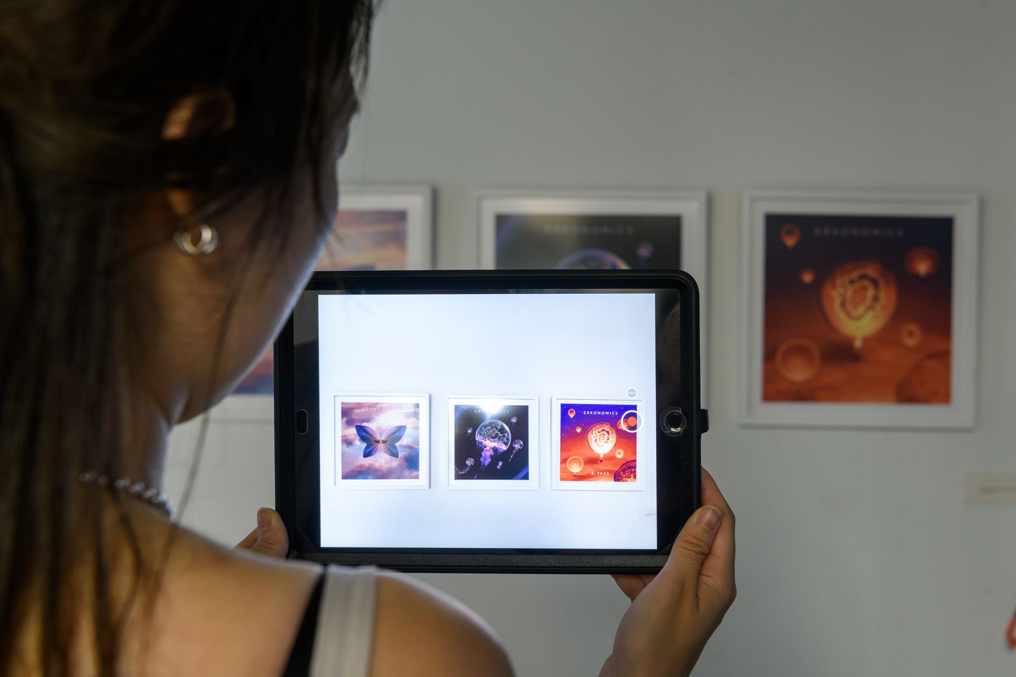 A person looking at augmented reality art work through an ipad