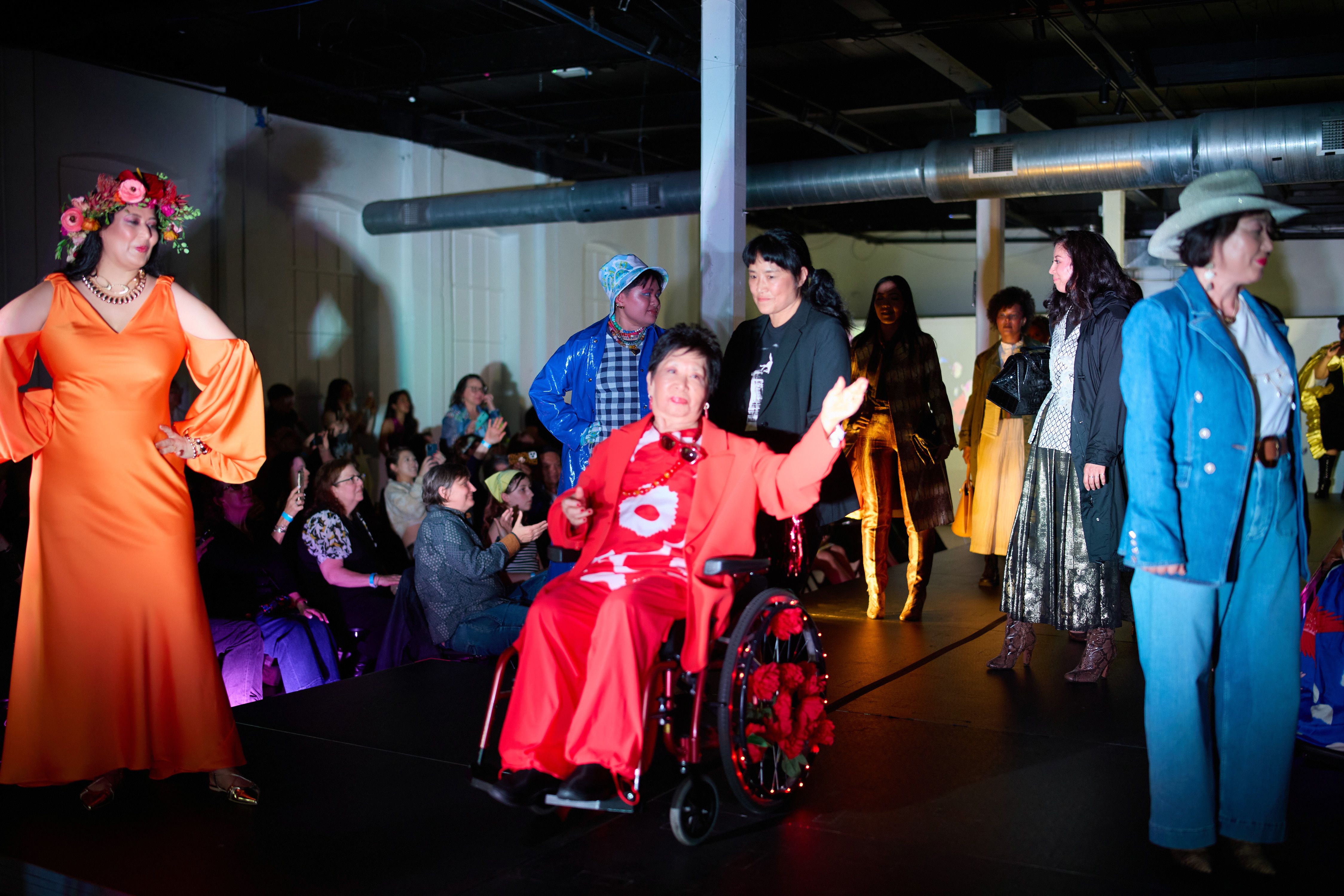 Mom fashion models on a runway showcasing their clothes as a whole wearing colorful dresses and outfits