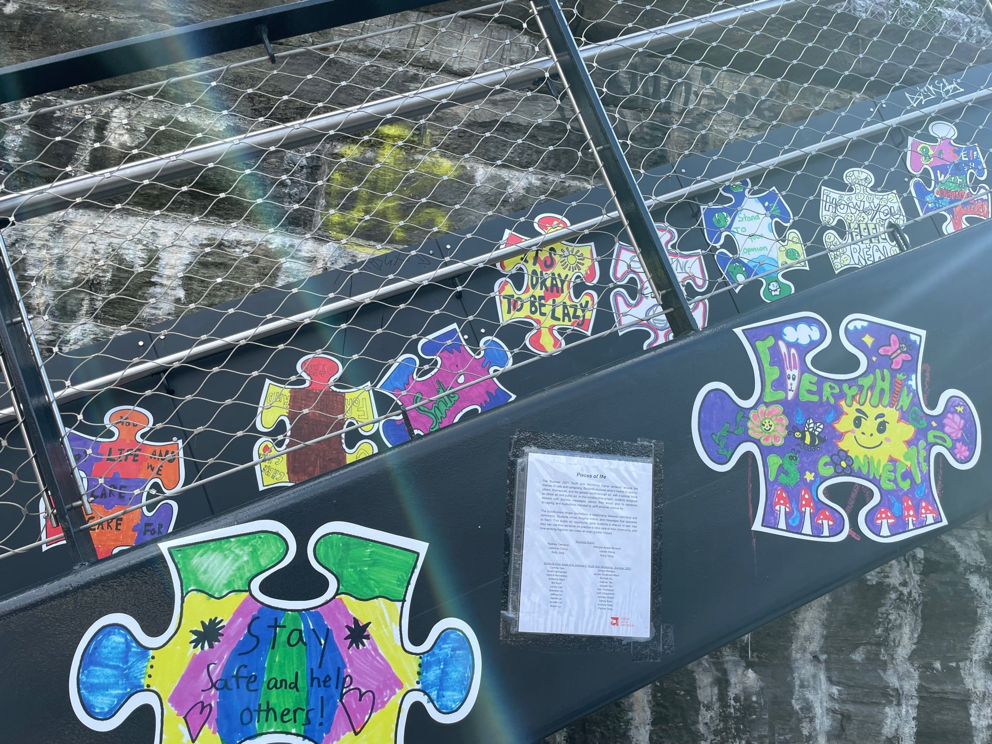 Illustrations on puzzle pieces painted on the stairs at Railway Park.