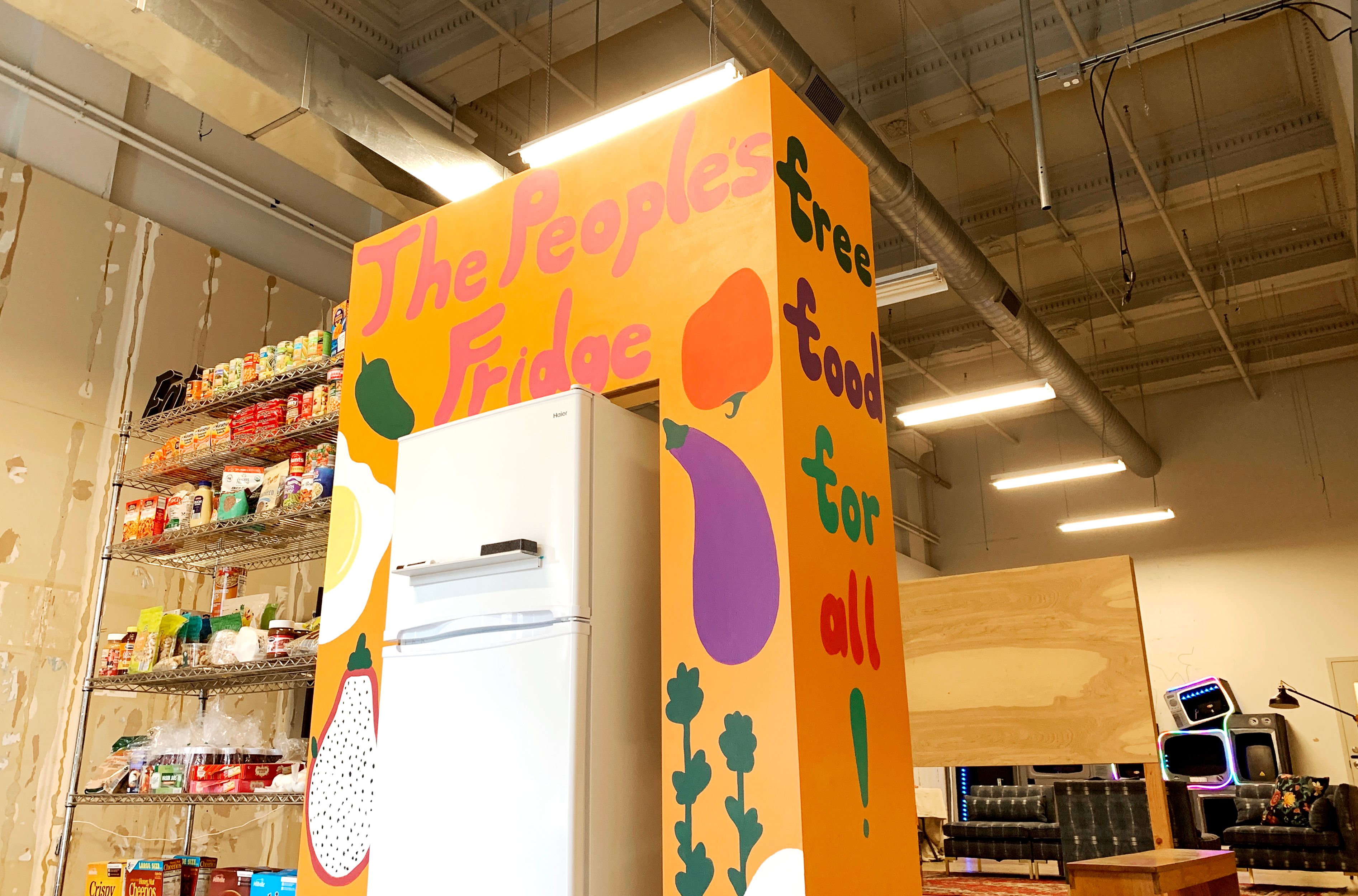 a refrigerator and a painted sign that says "The People's Fridge" 