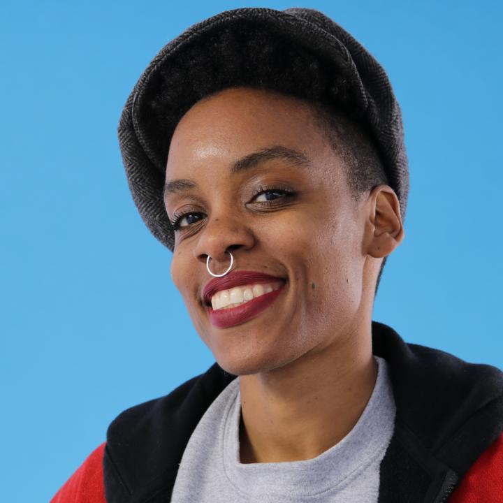 Headshot of Golden Collier in front of a light blue background.