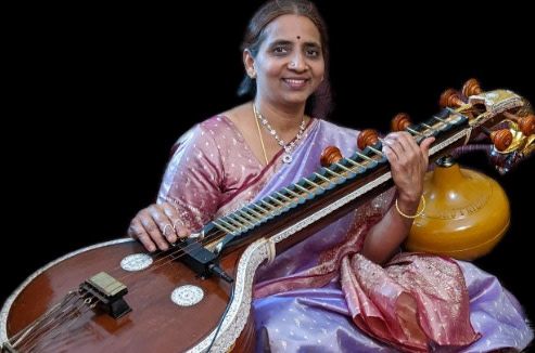 Musician Bhuvana Kannan sitting with her veena.