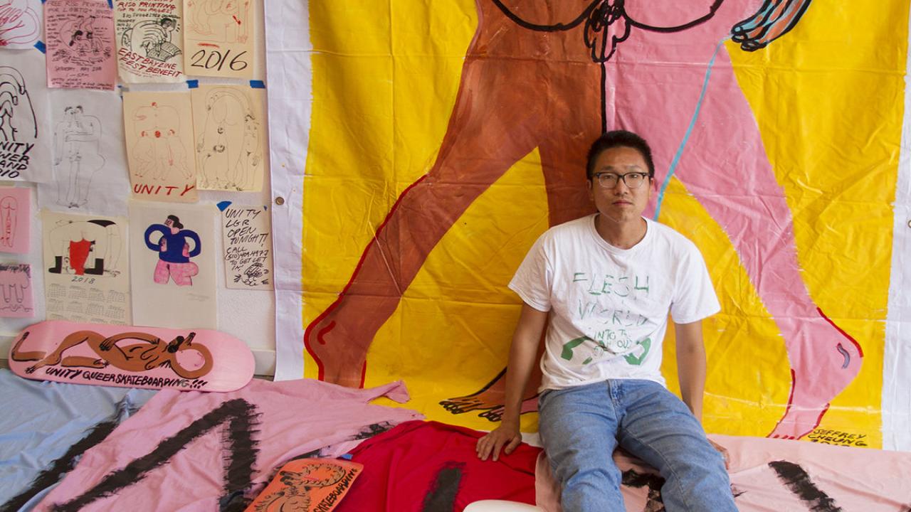 Portrait of Jeffrey Cheung in front of an illustrated portrait of human bodies.
