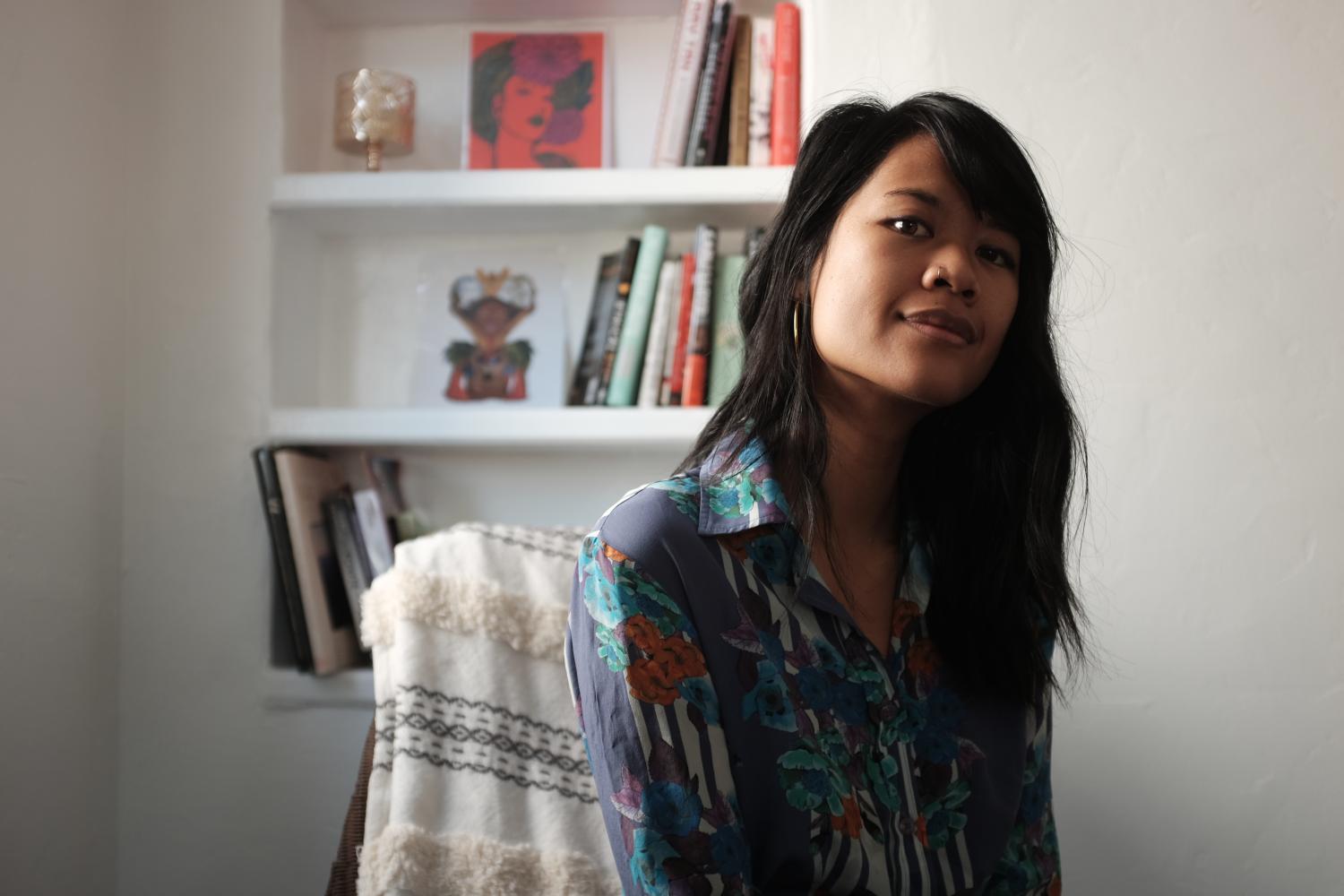 Portrait of Natalie Bui in front of a bookshelf.
