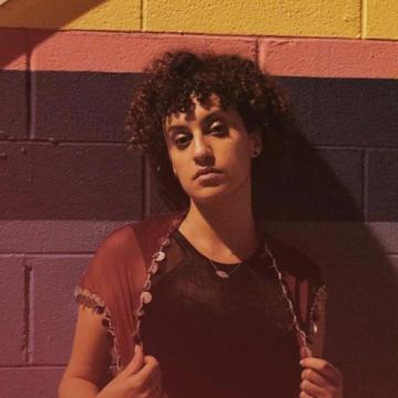 Rana Ransom in front of a colorful wall with stripes.