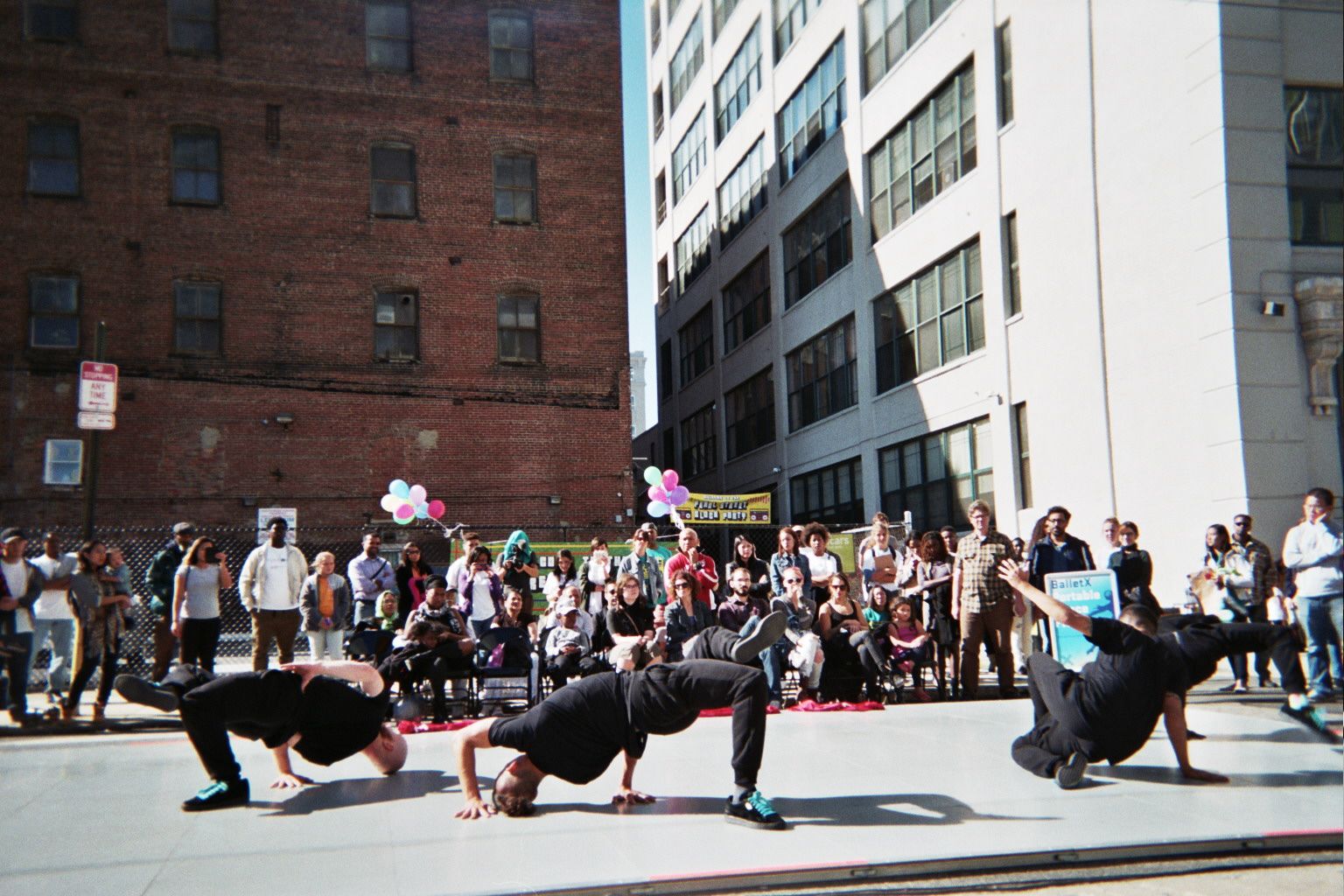 Artists break dancing in front of audiences at Pearl Street Block Party.