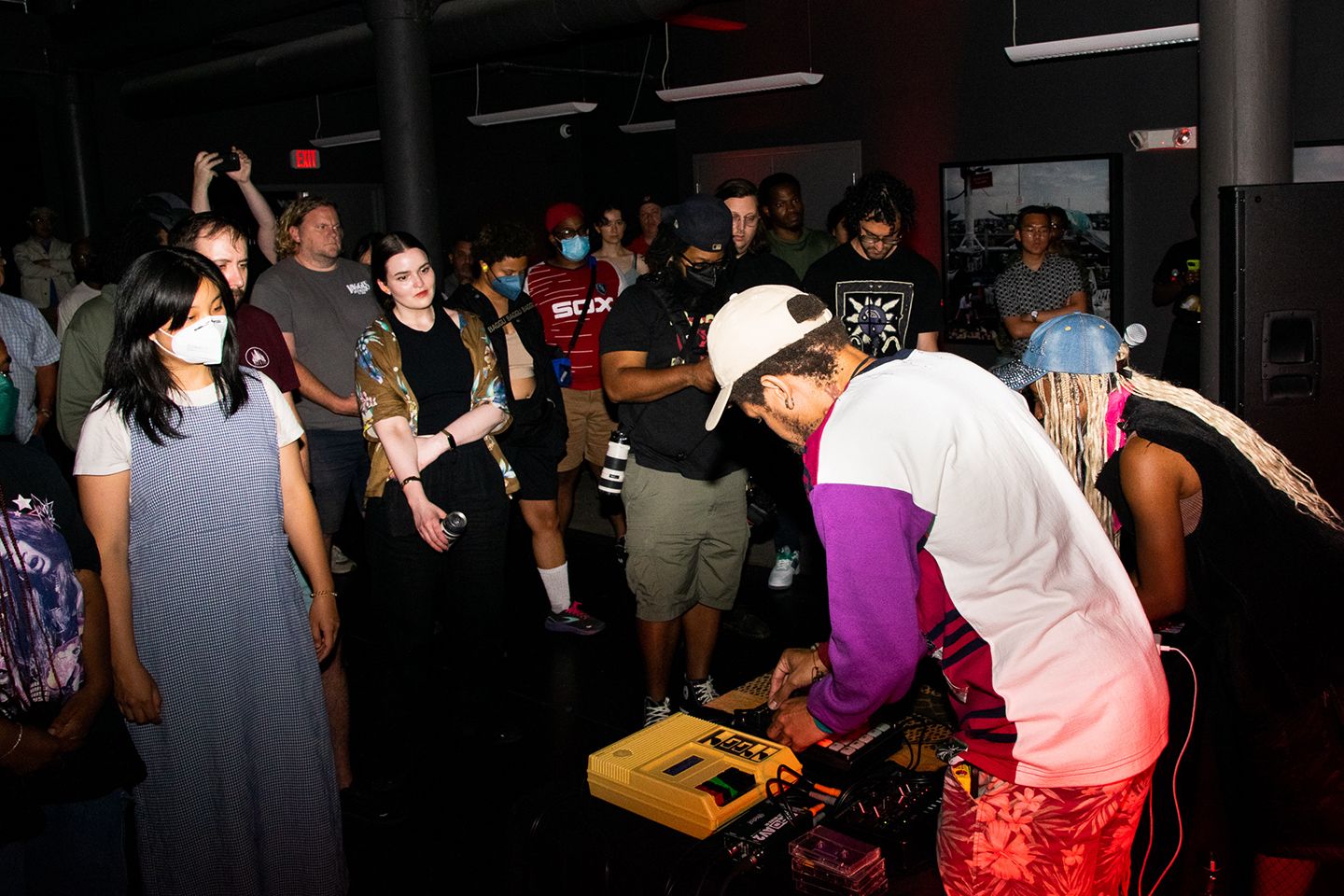 Two DJs playing a set while a big crowd is watching and enjoying the music