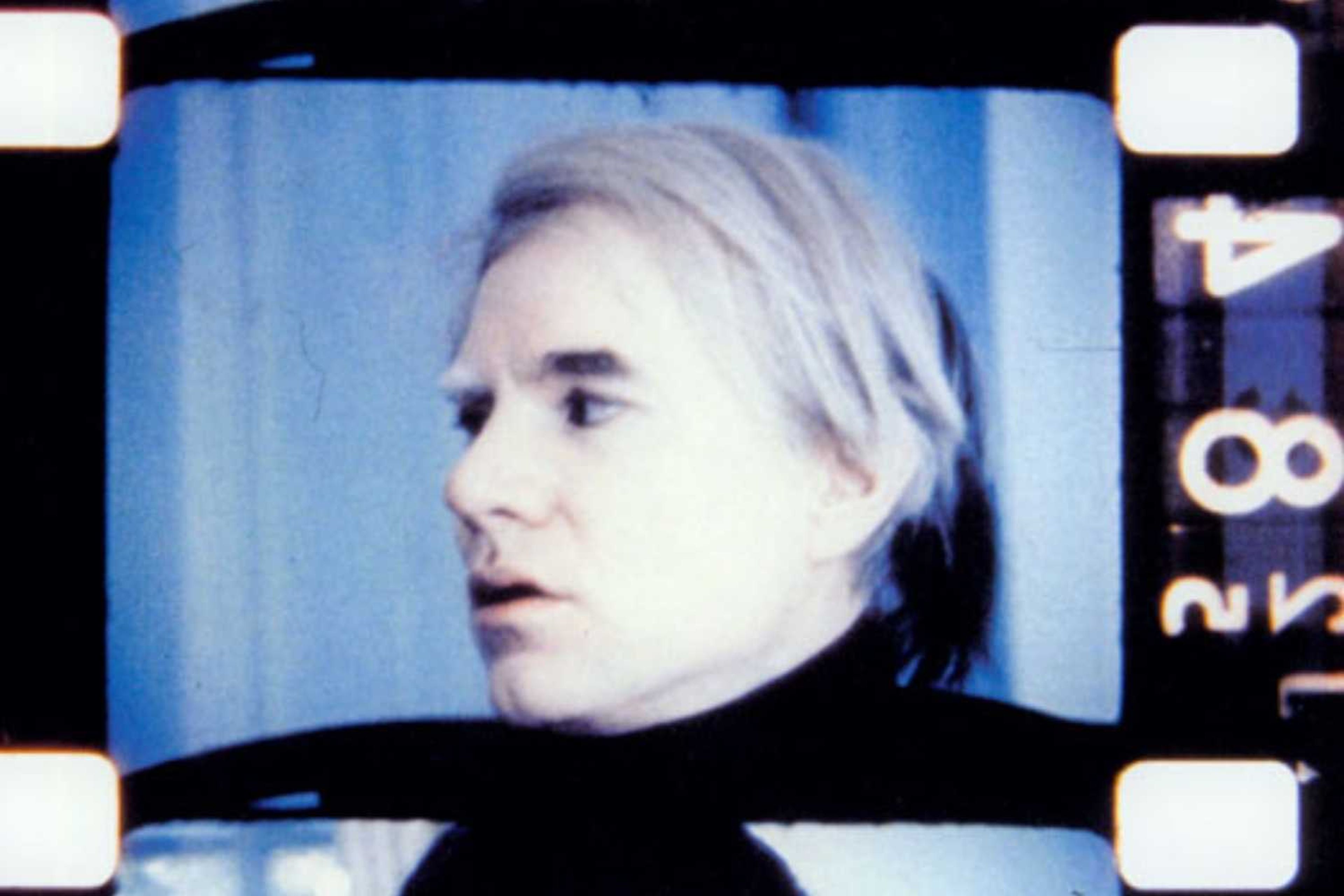 A still from 'Scenes from the life of Andy Warhol' showing some shots of Warhol on some old 35mm film.