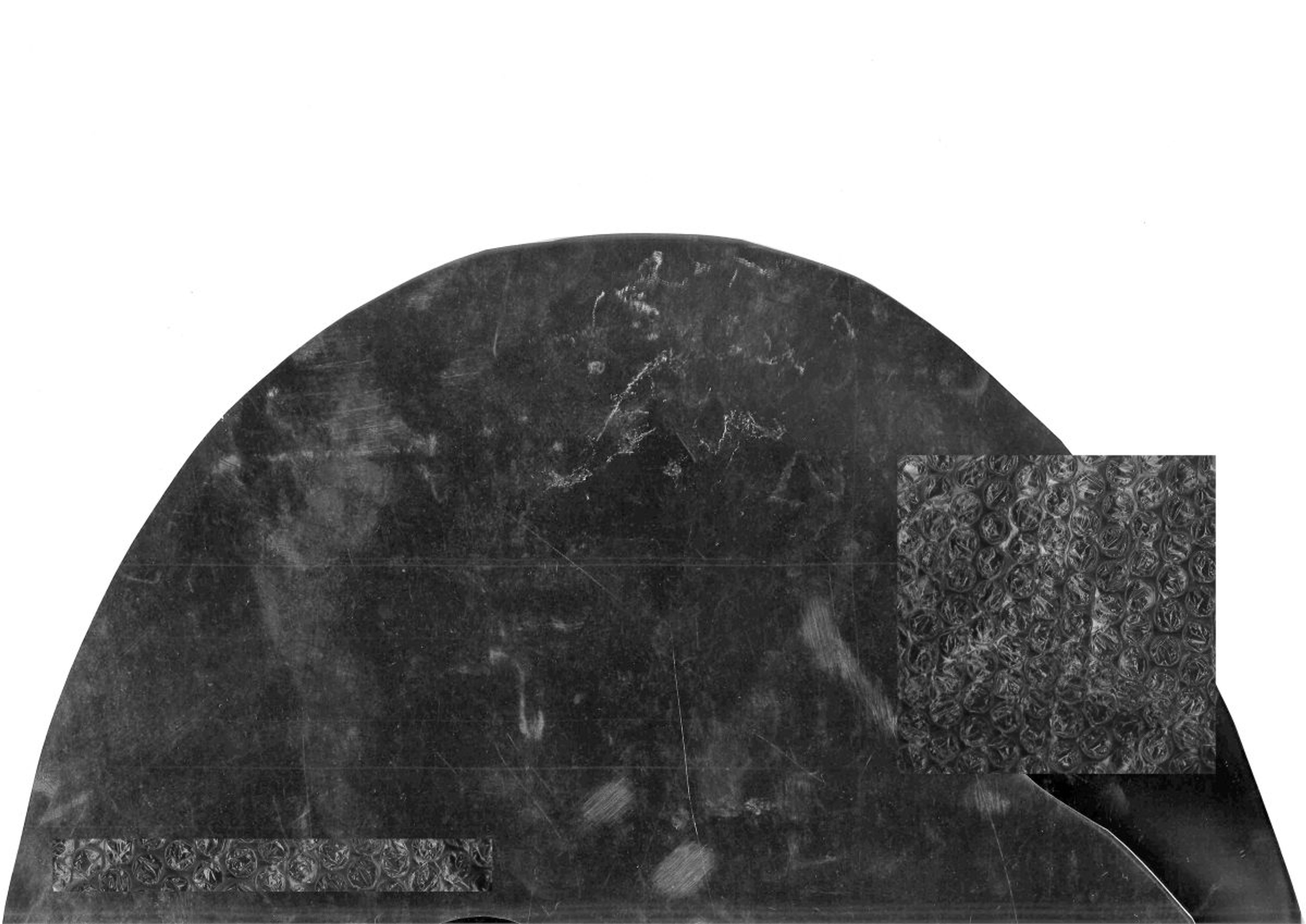 A greyscale collage-style rock in the shape of a half-circle, against a white background. A square with grayscale rock pattern overlays on the right.