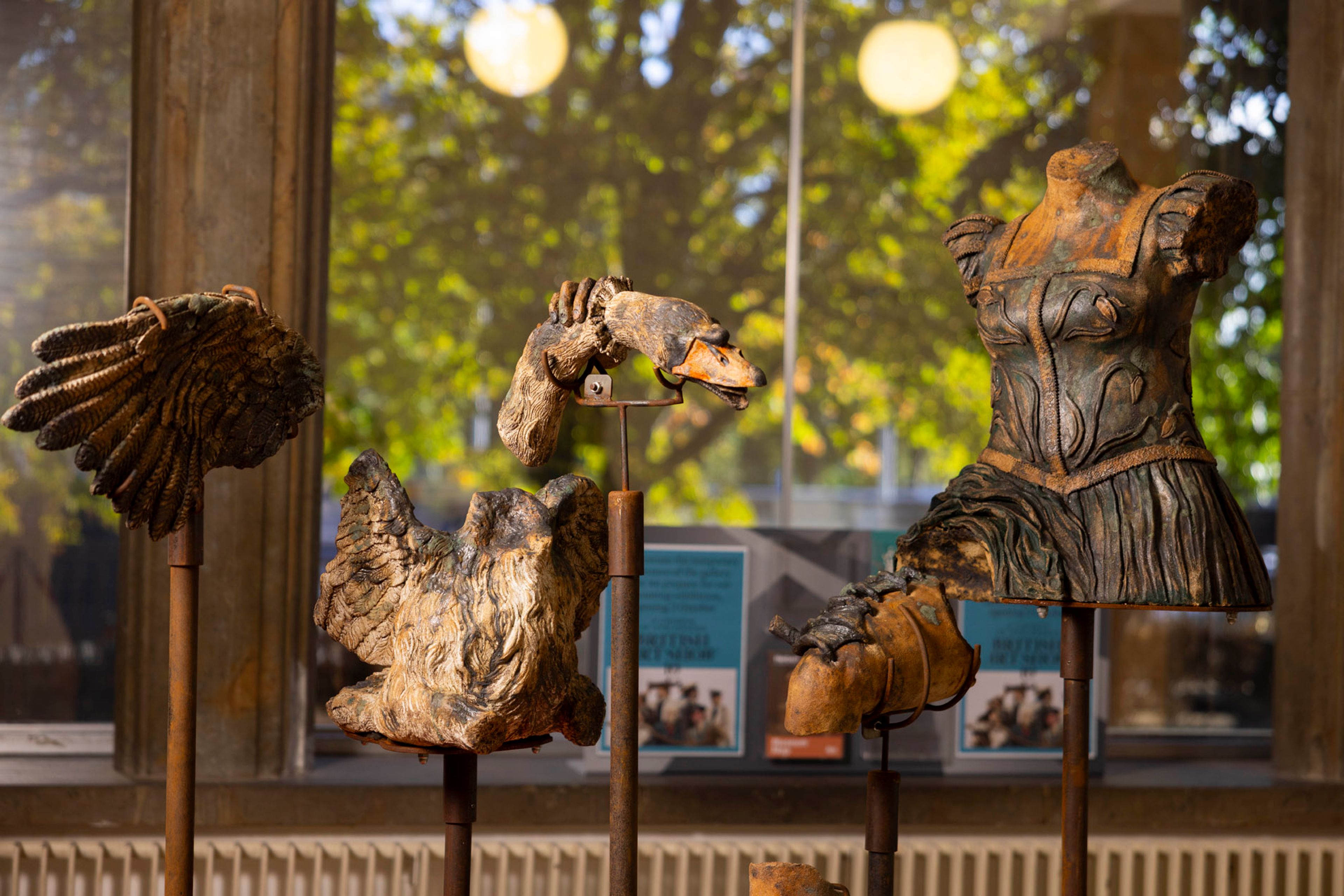 Cast ceramic objects propped on stands.