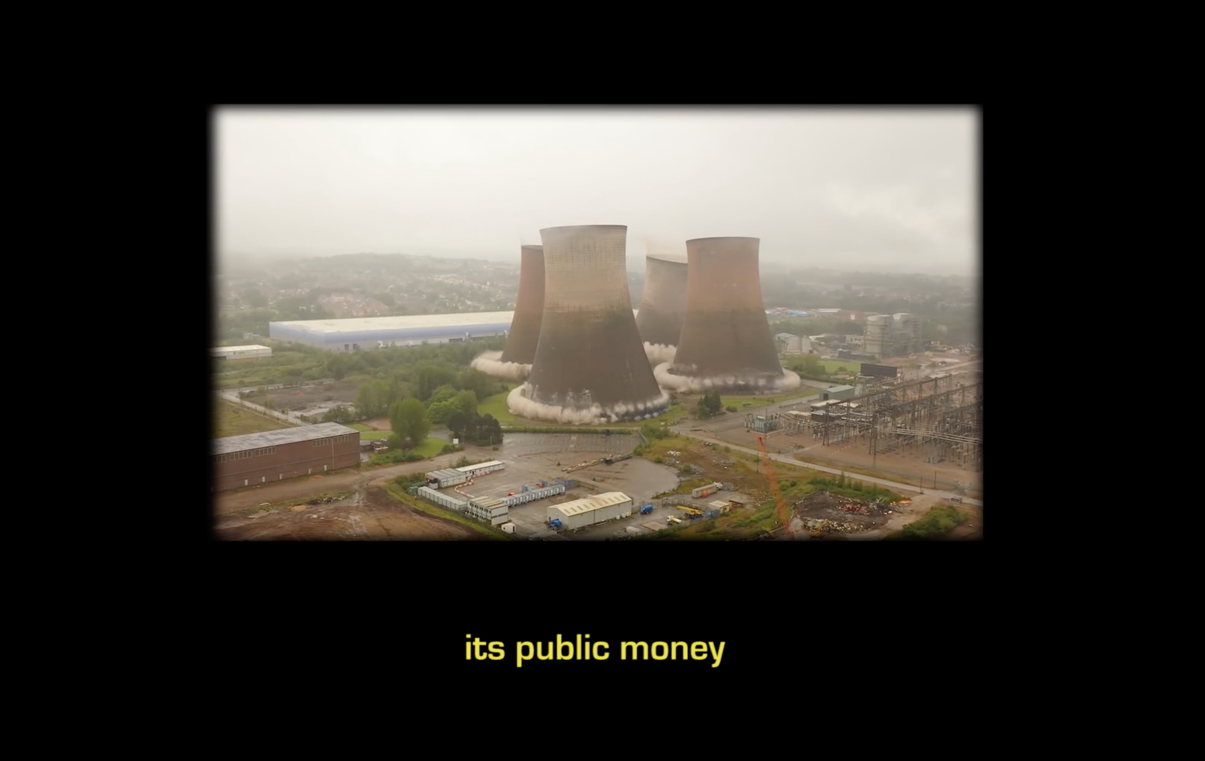 Still of power plant demolition with subtitles reading "its public money"