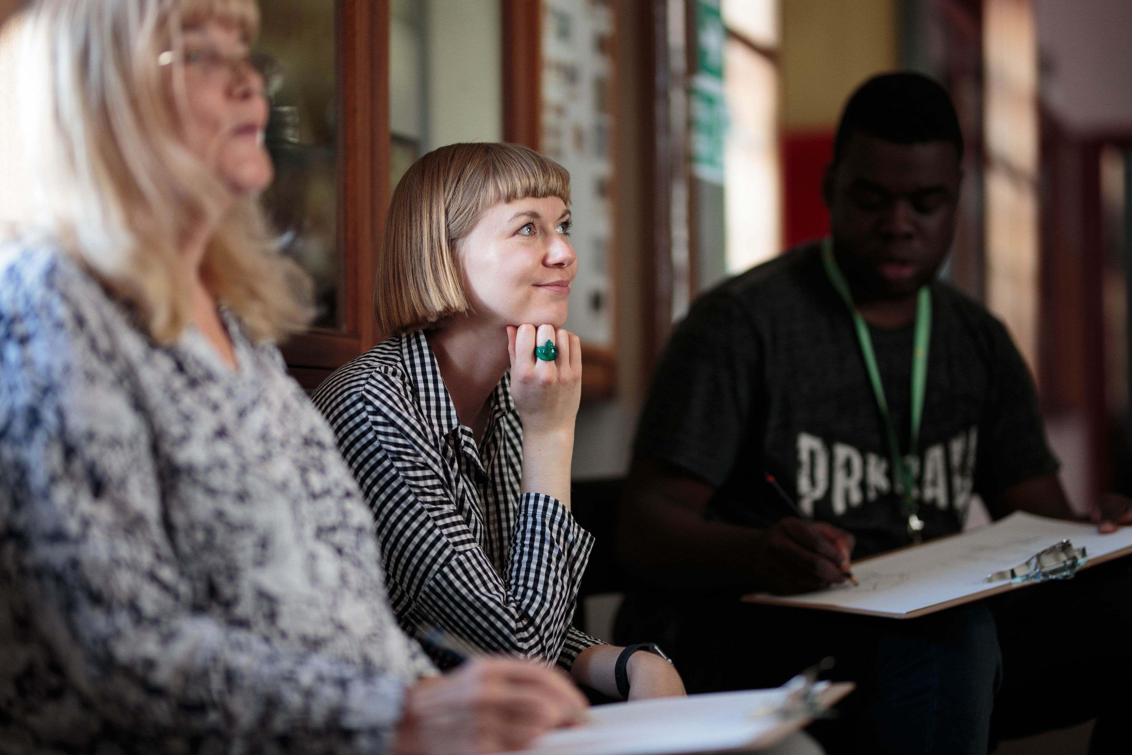Colette Griffin looking out to the right during a drawing workshop.