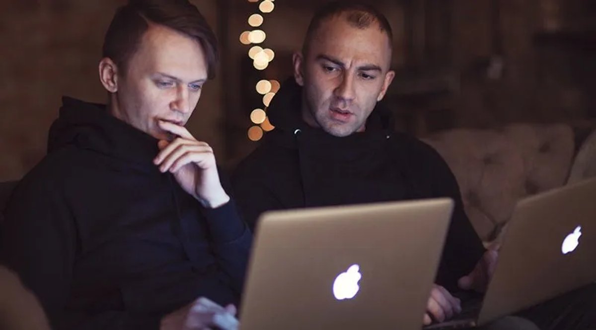 two-men-collaborating-macbooks