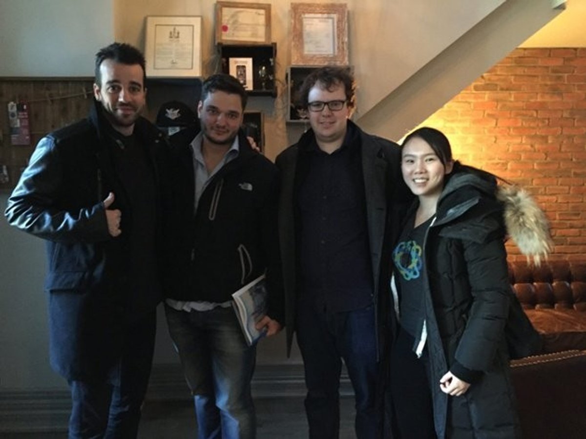 Close team members with two people from a customer’s team, posing together during a visit in Ottawa.