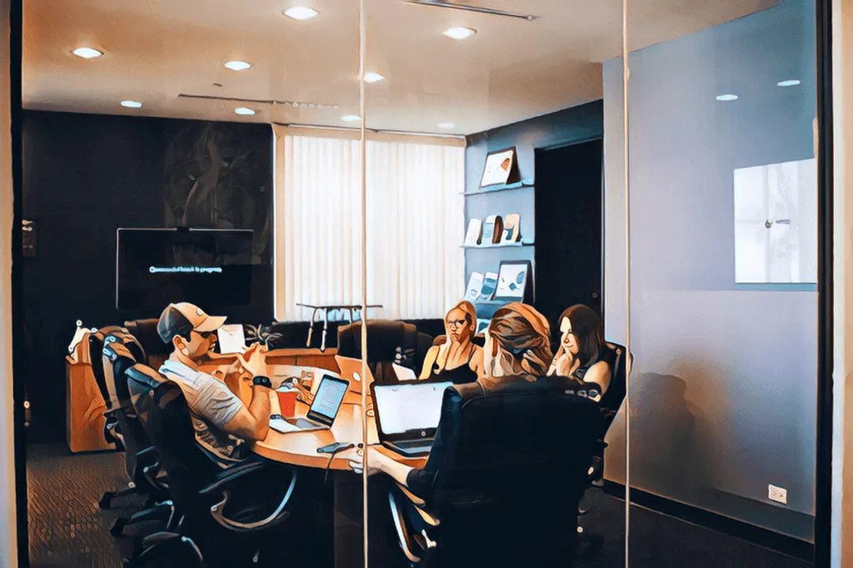 Sales strategy guide image of people in a conference room