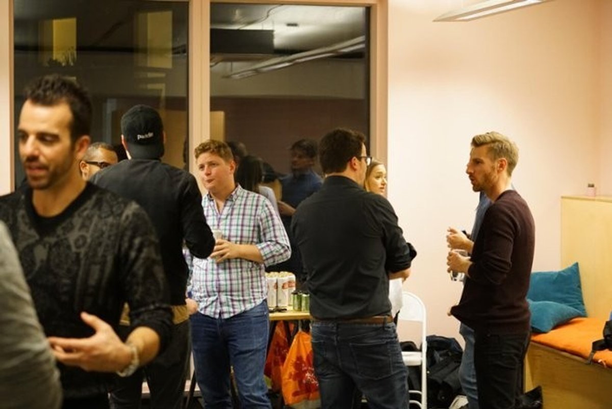 Attendees talking in small groups at a Close customer meetup.