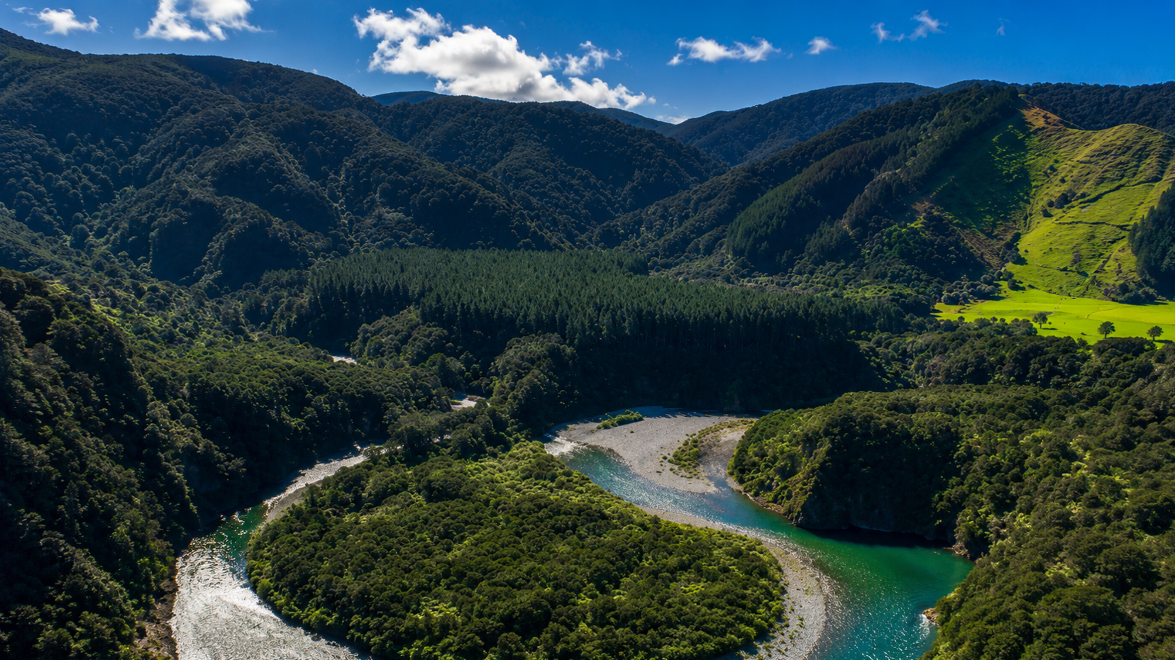 River bending through dense bush hills