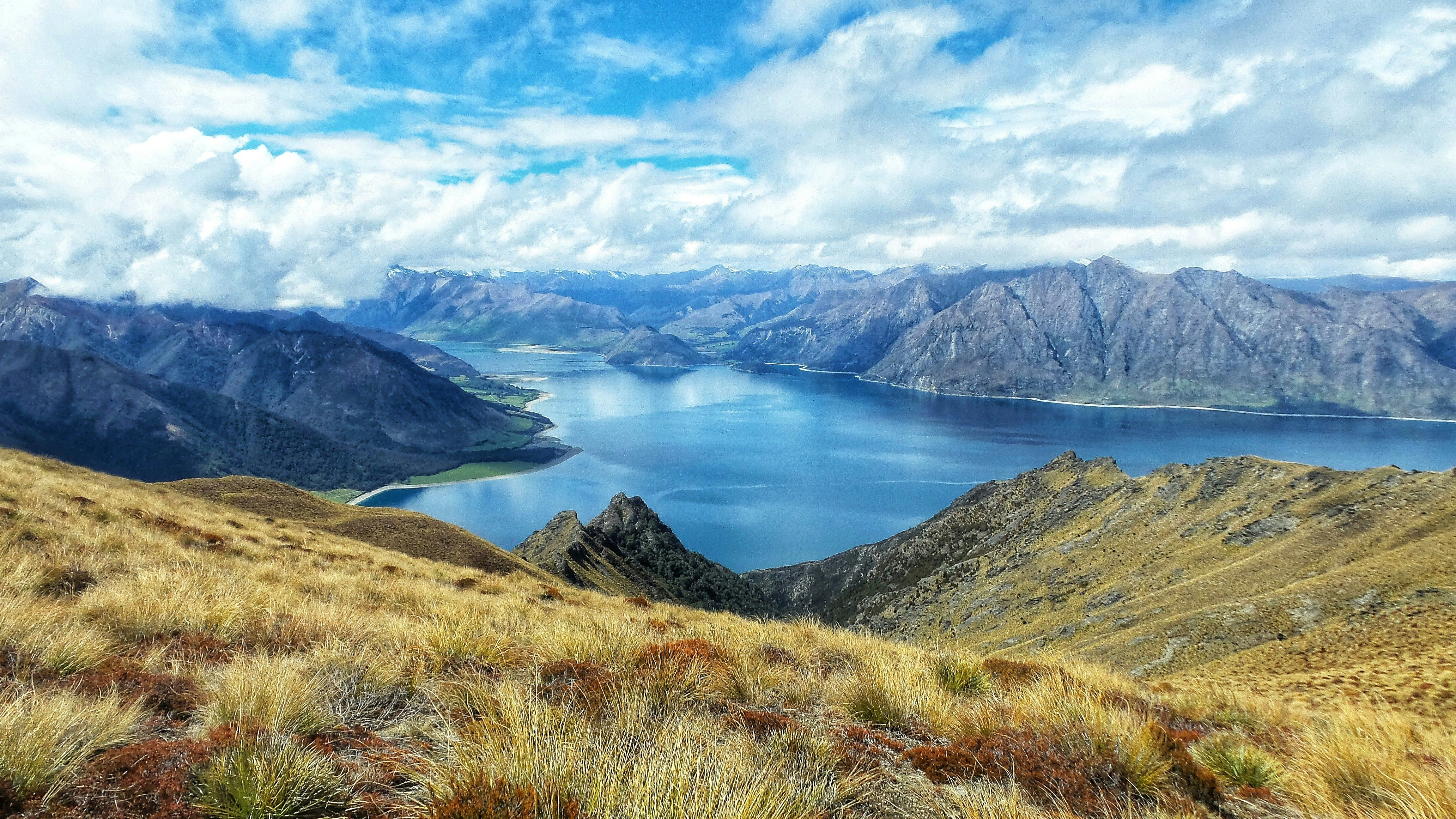 Tussock ridgeline above a large lake and bare ranges