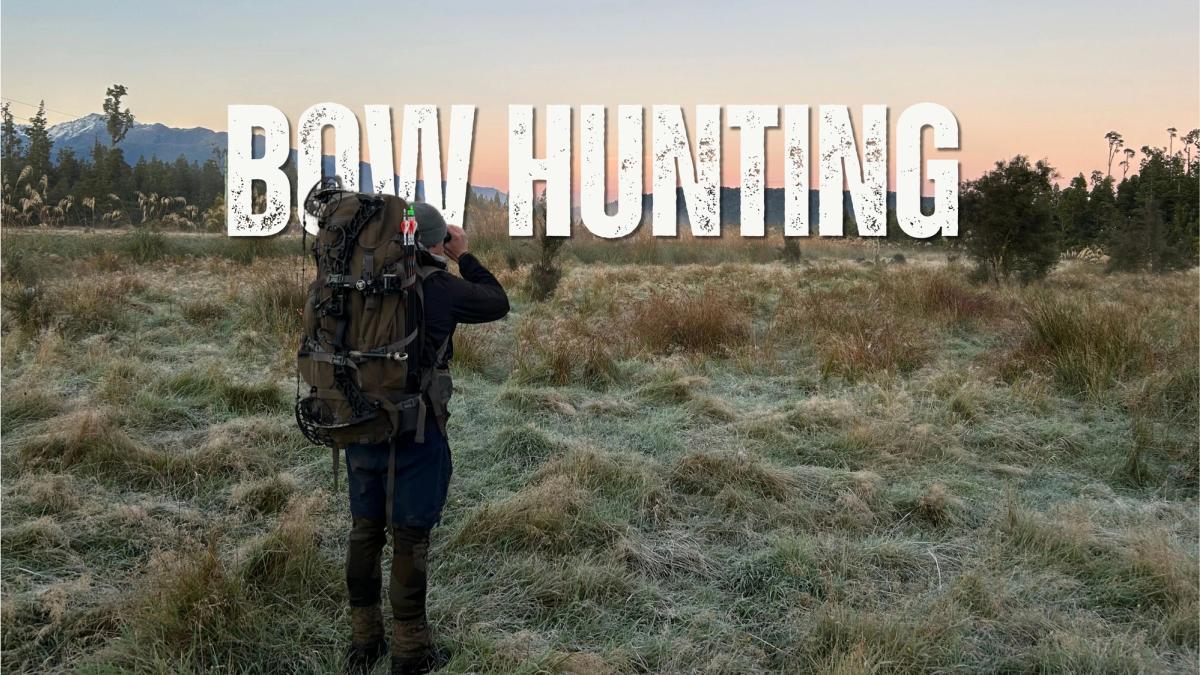Hunter with a compound bow glassing for deer