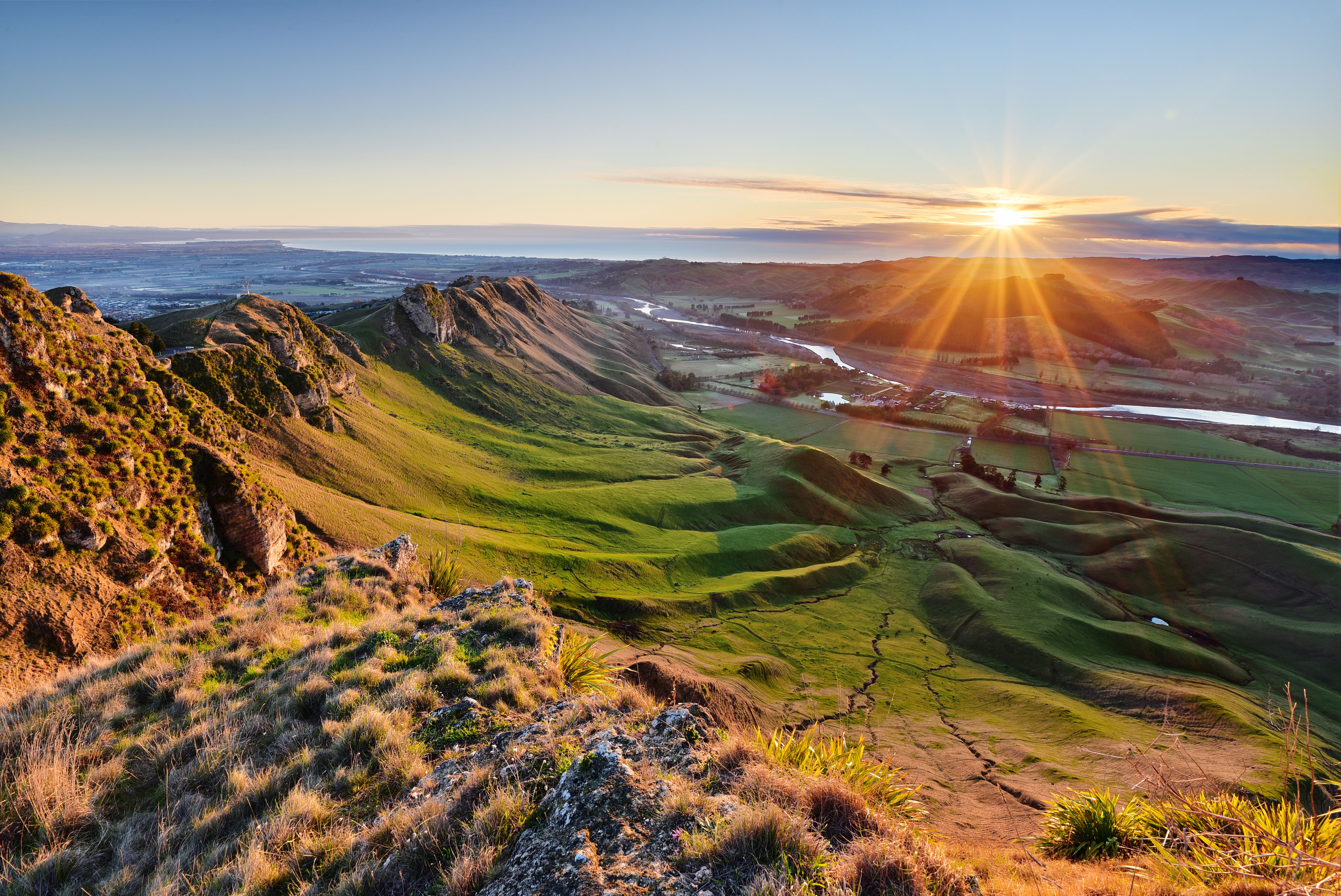 Sun rising over folded golden hill country