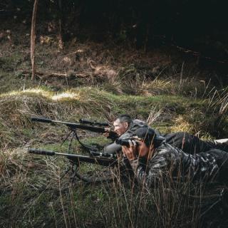 Hunters laying prone glassing for deer