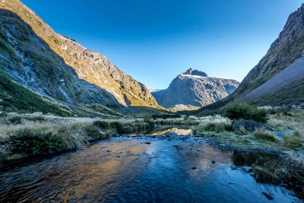 Clear river running through a golden alpine valley