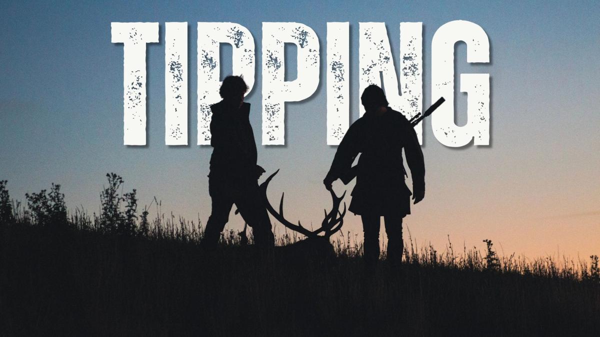 Two hunters silhouetted against a dusk sky, dragging a stag by its antlers through long grass, one with a rifle slung over his shoulder, with the word "Tipping" in bold distressed lettering across the top.