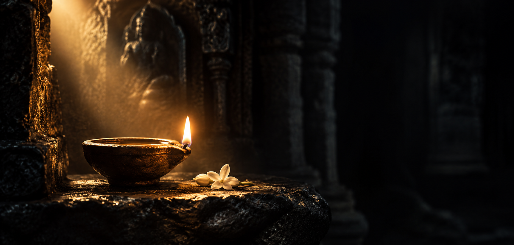 A single clay oil lamp burning in a dark stone niche, its flame the only light.