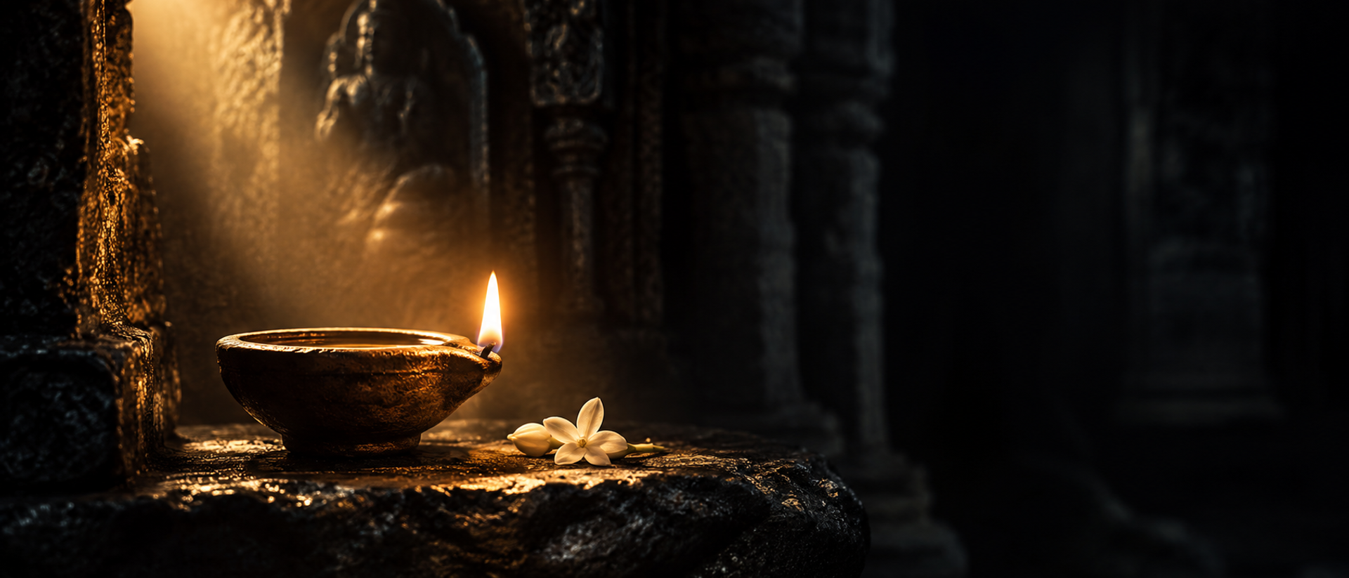 A single clay oil lamp burning in a dark stone niche, its flame the only light.