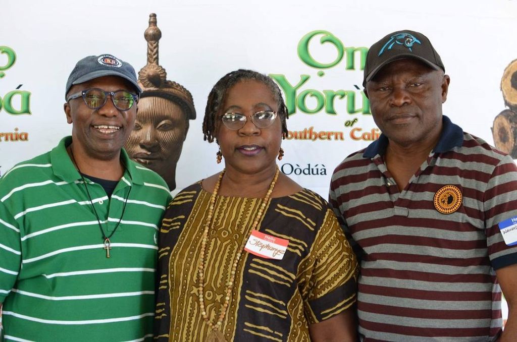 Three members in front of the Omo Yorùbá banner
