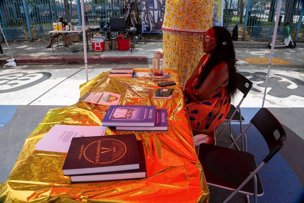 Books on Ifá and Yoruba language laid out on a gold cloth