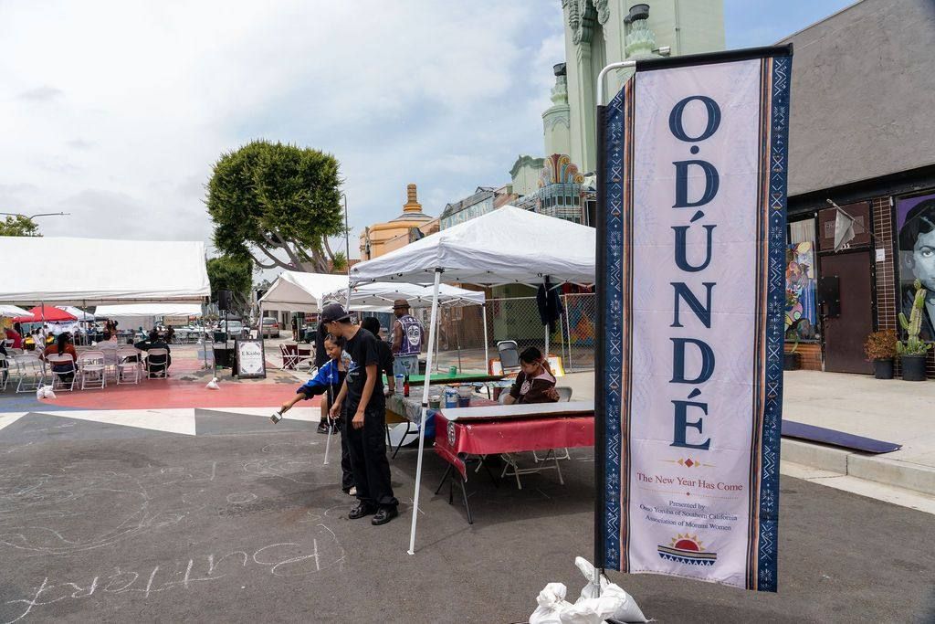 The Odunde feather flag beside the plaza, the Vision Theatre behind