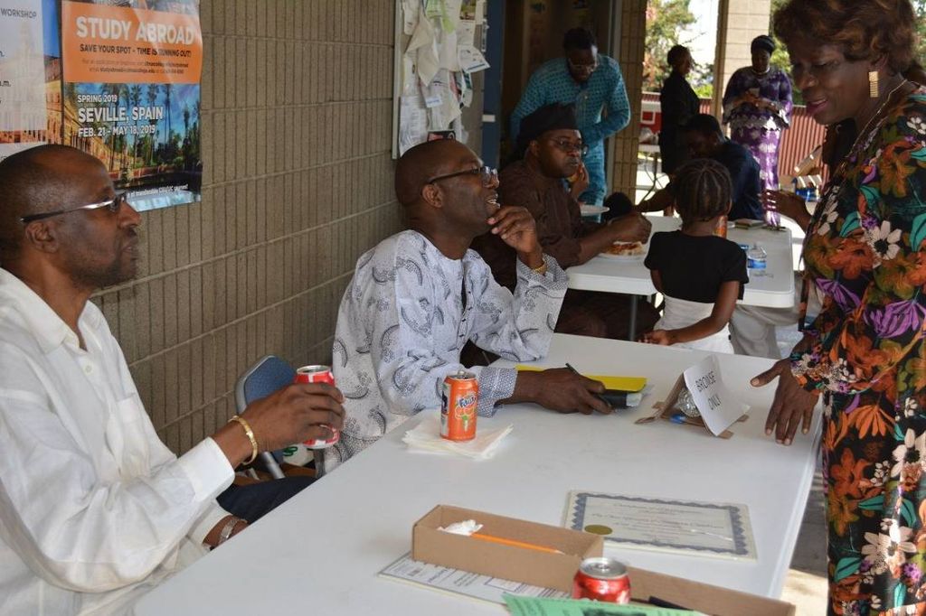 Members at the registration table under the breezeway