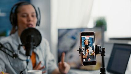 Young female microphone recording tik tok blue color scheme