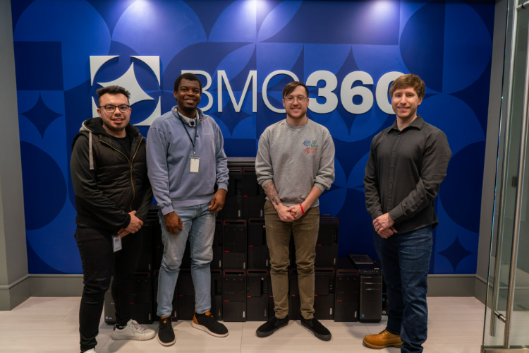 BMG360 employees standing in front of BMG360 sign