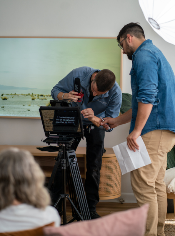 creative film team on set setting up a teleprompter