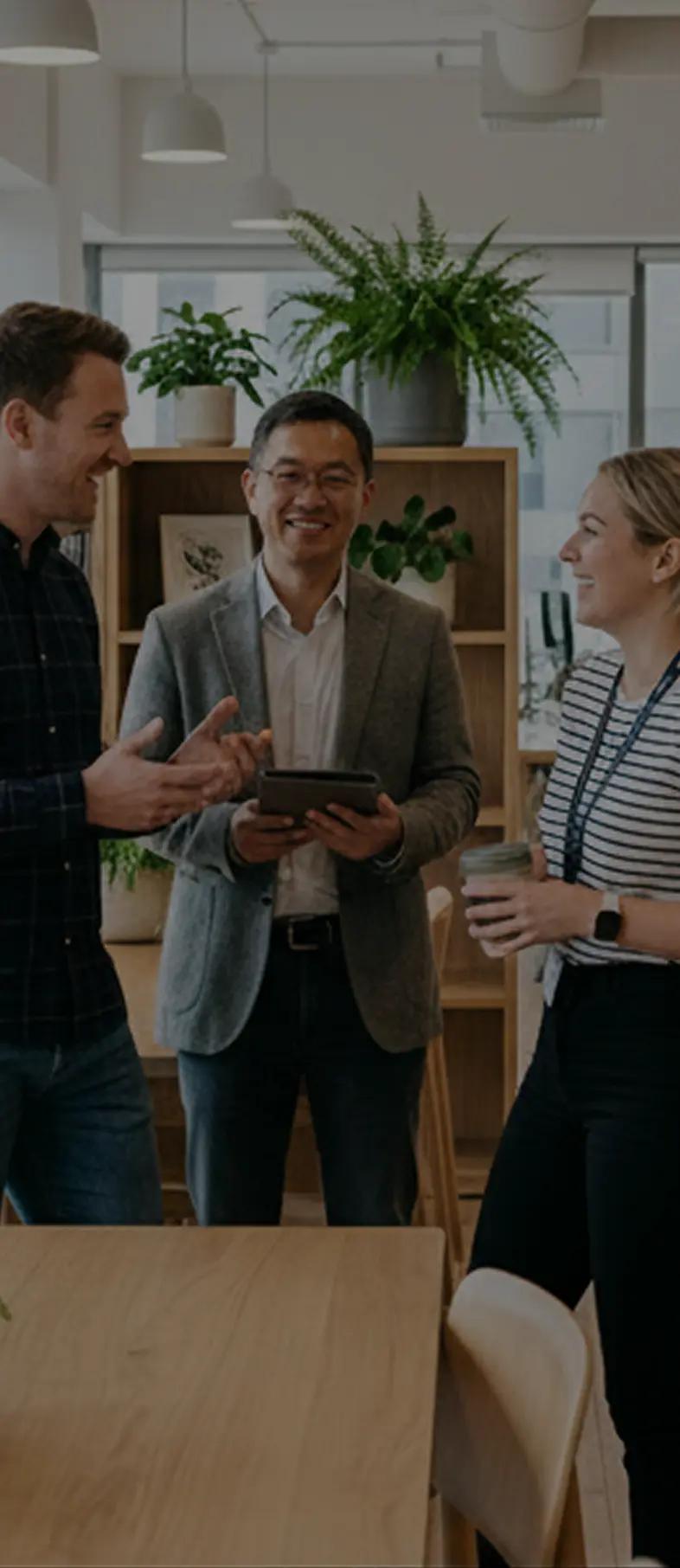Group of people in an office, smiling.