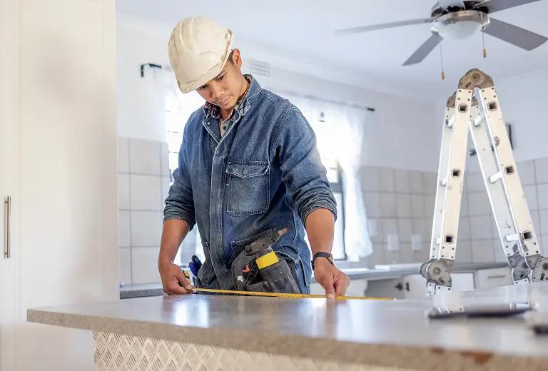 Person measuring a countertop.