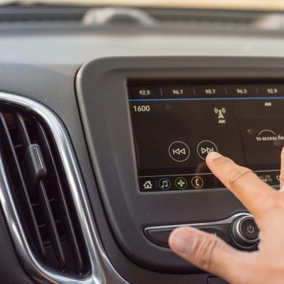 Photo showing a hand changing the car radio