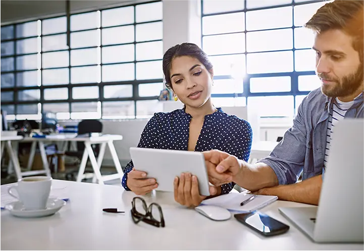 Group of people in a meeting, smiling.