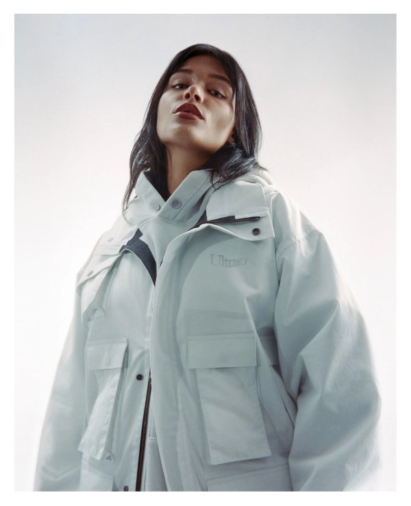 Portrait of a model in a mint Ultrace jacket shot from below on medium format film