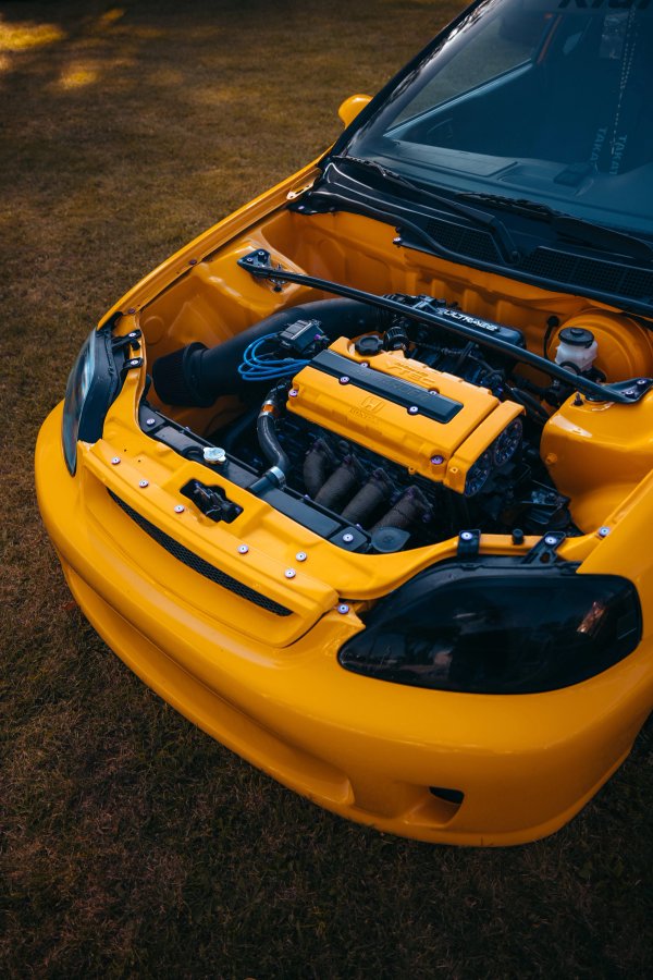 Yellow Honda Civic EK engine bay with color-matched B-series swap