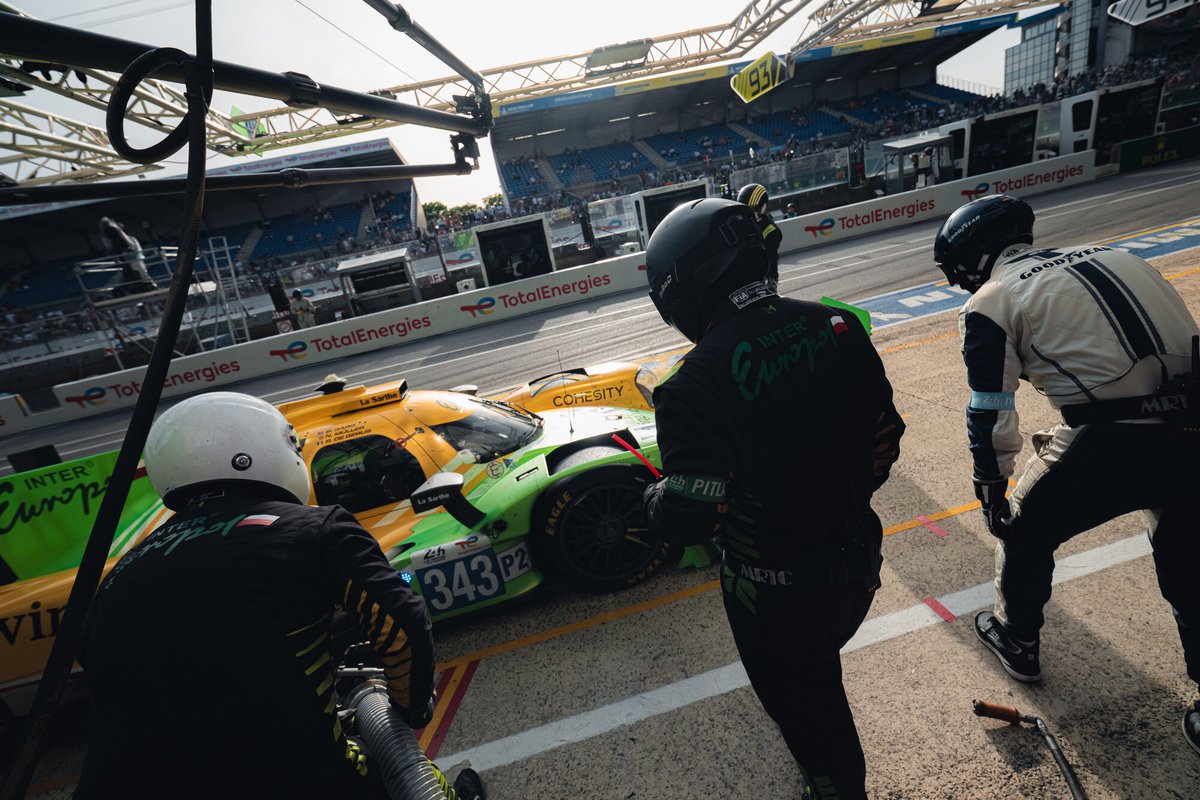 Inter Europol Competition number 343 Oreca LMP2 in the pit box during a daytime stop, crew working around the car