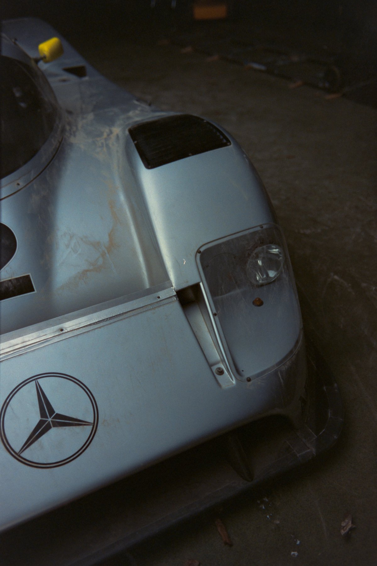 C11 nose detail showing Mercedes three-pointed star on bonnet with dust stains on silver paint