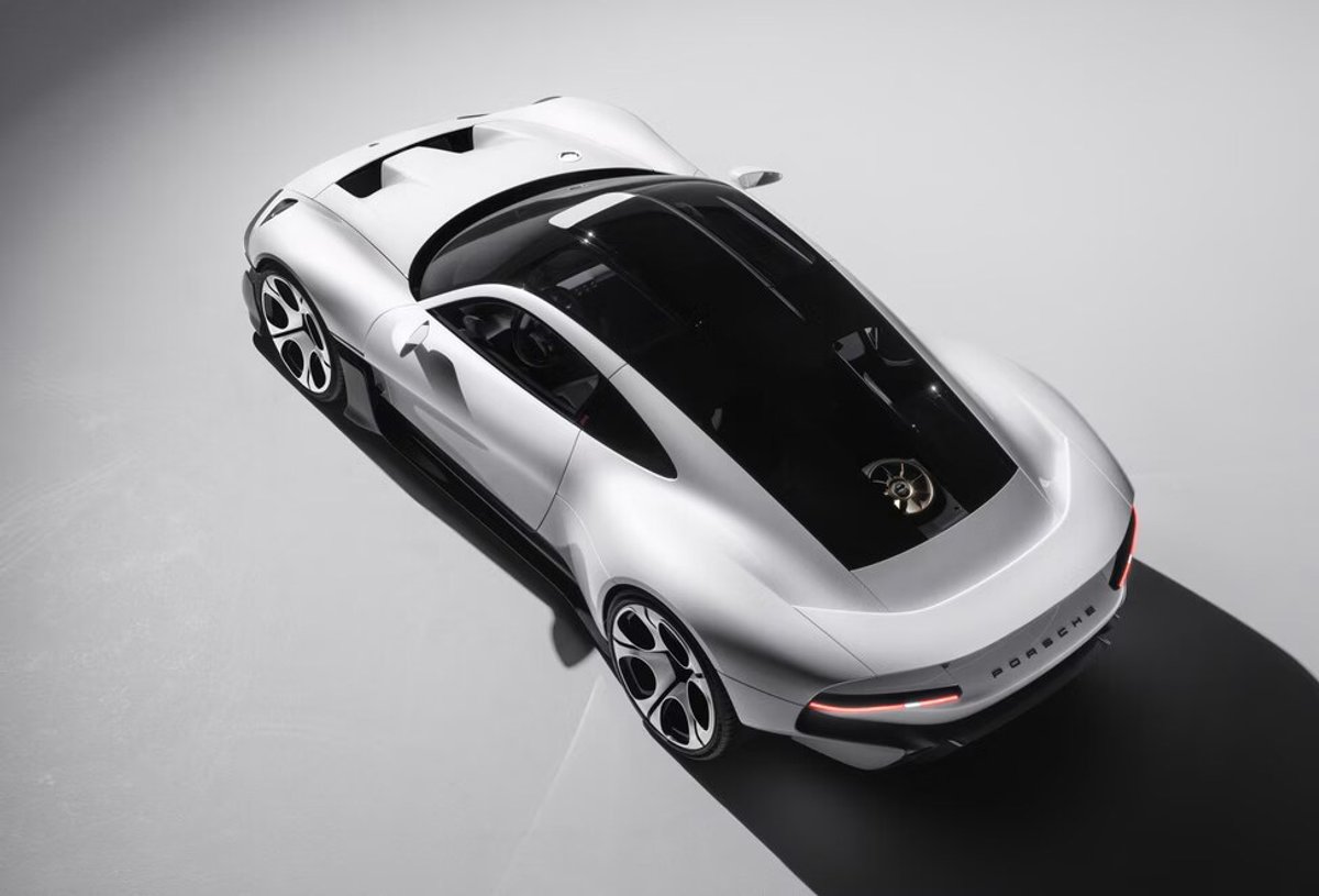 The Porsche Mission S from above and behind, with a full-width light bar and its long shadow falling across the floor